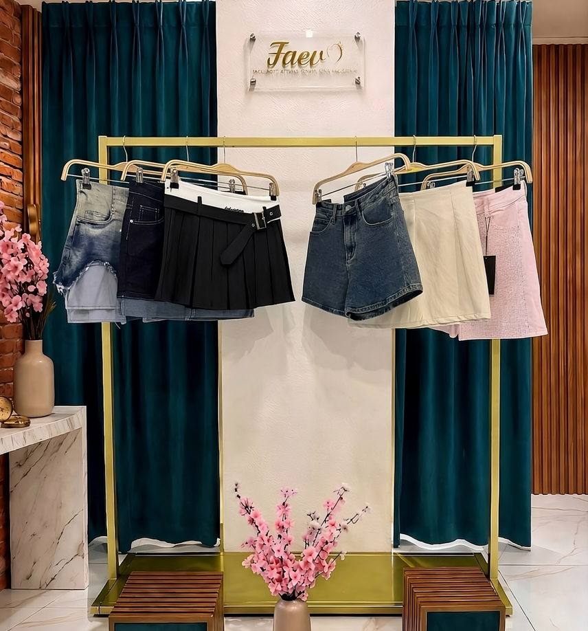 Stand espositivo con assortimento di gonne corte da donna e shorts di tendenza nella boutique FAEV Abbigliamento.